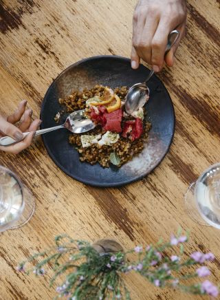 Couple enjoying food and drink at Zecca Restaurant, Griffith